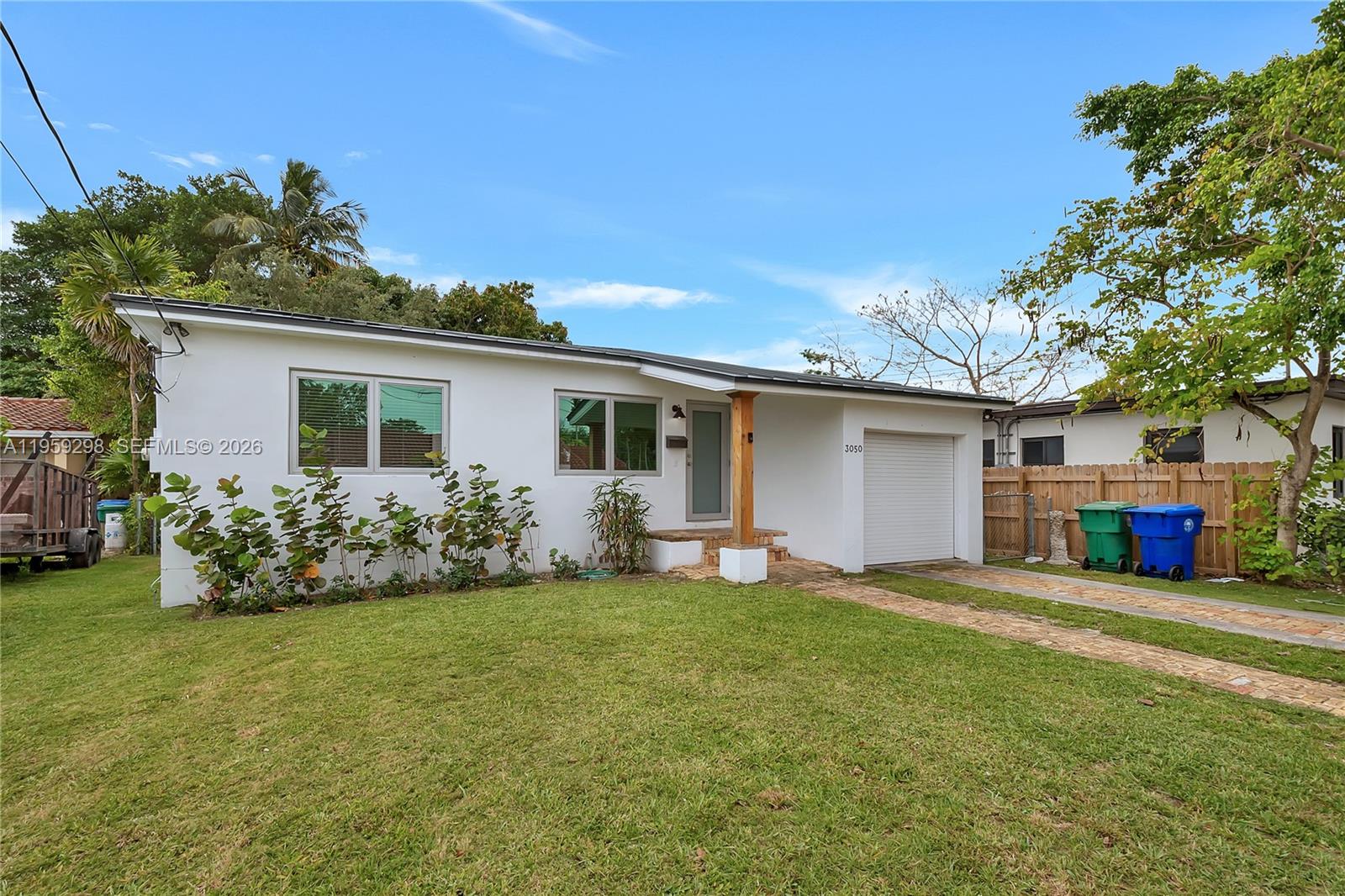 3050 Southwest 23rd Terrace Miami, FL 33145 - Photo 5 of 22 a view of a house with a yard and pathway