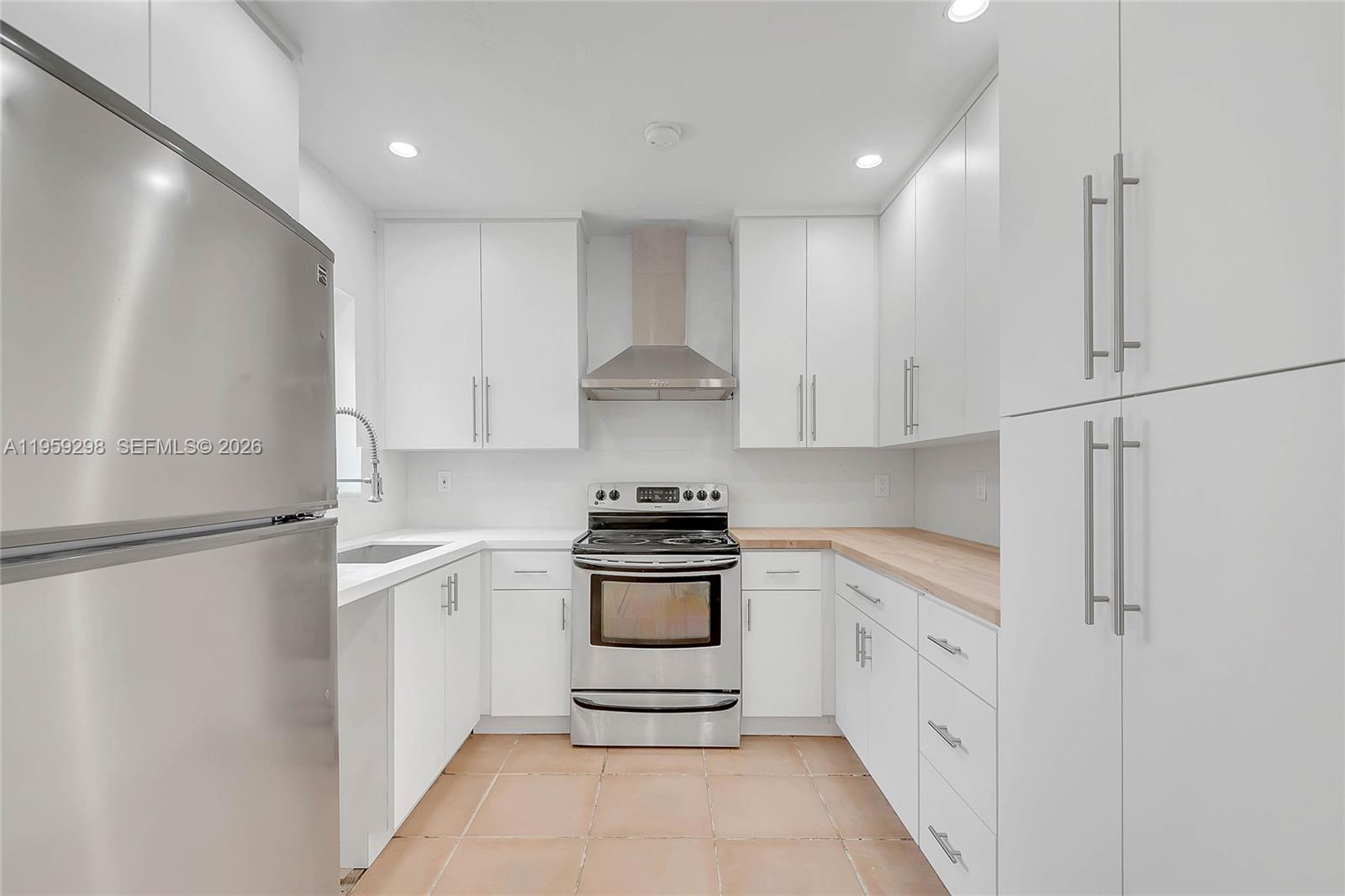 3050 Southwest 23rd Terrace Miami, FL 33145 - Photo 8 of 22 a kitchen with white cabinets and white appliances