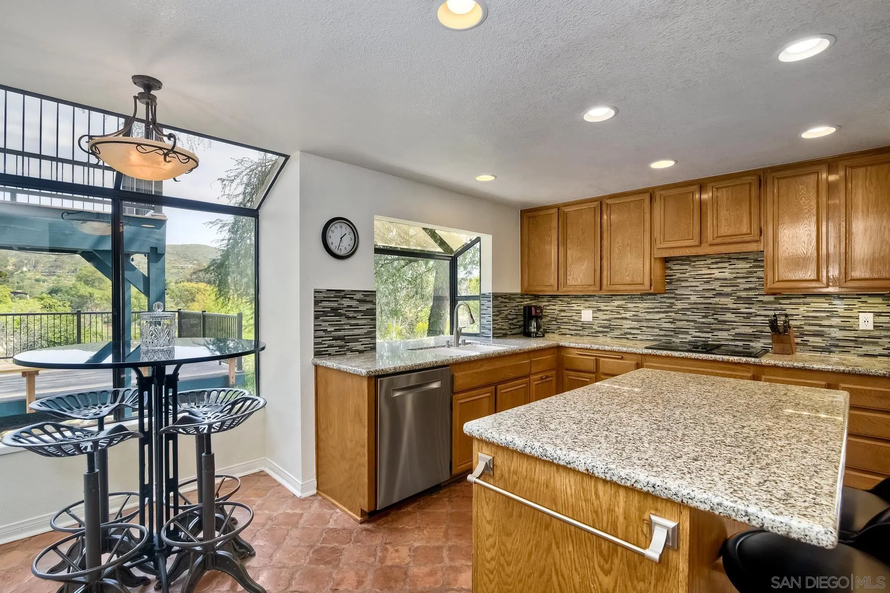 14859 Derringer Road Poway, CA 92064 - Photo 14 of 39 a kitchen with stainless steel appliances granite countertop a sink a stove and a wooden floors