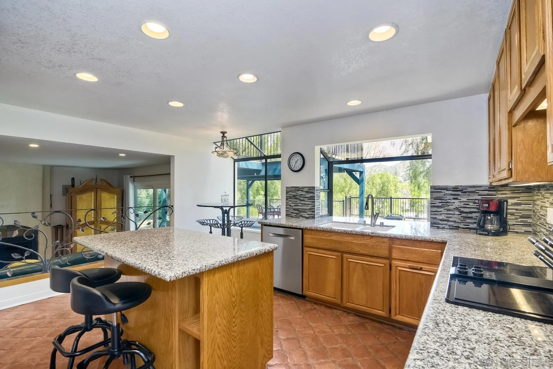 14859 Derringer Road Poway, CA 92064 - Photo 15 of 39 a kitchen with stainless steel appliances granite countertop sink stove and wooden cabinets