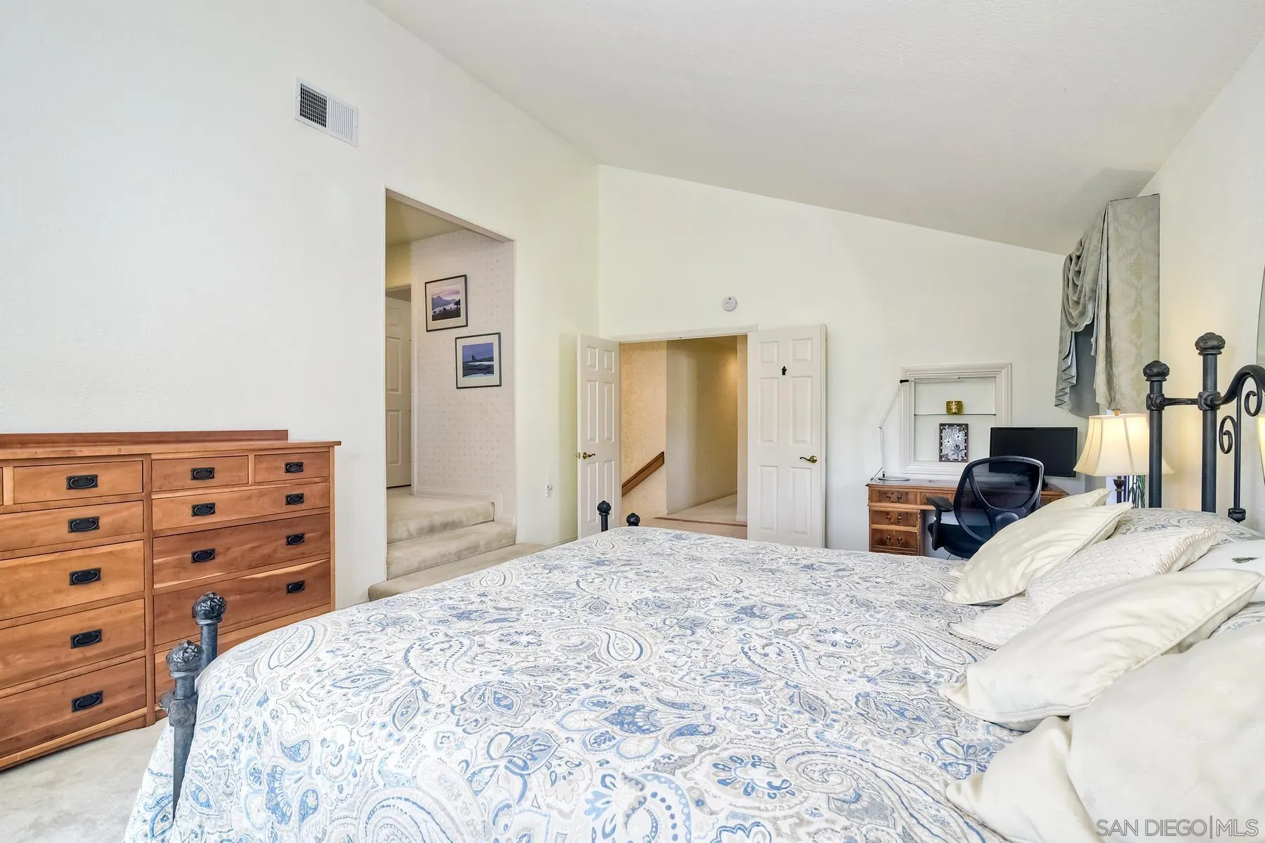 14859 Derringer Road Poway, CA 92064 - Photo 22 of 39 a large bedroom with a bed a dresser and book shelf