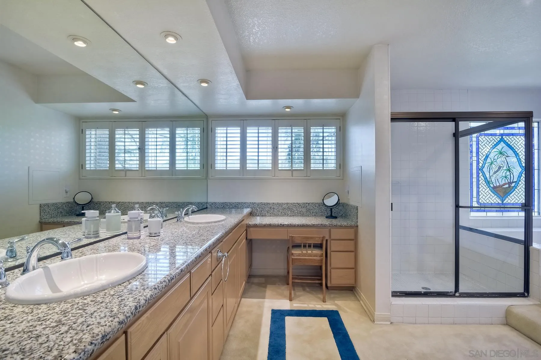 14859 Derringer Road Poway, CA 92064 - Photo 26 of 39 a bathroom with a granite countertop sink a mirror and a bathtub