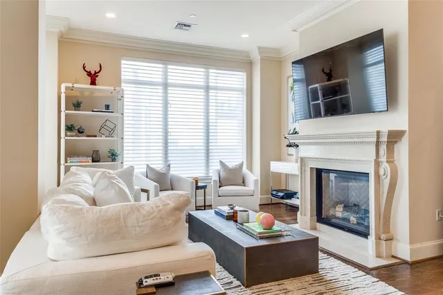 a living room with furniture fireplace and flat screen tv
