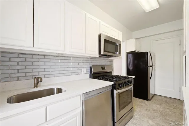 a kitchen with stainless steel appliances a refrigerator and a sink