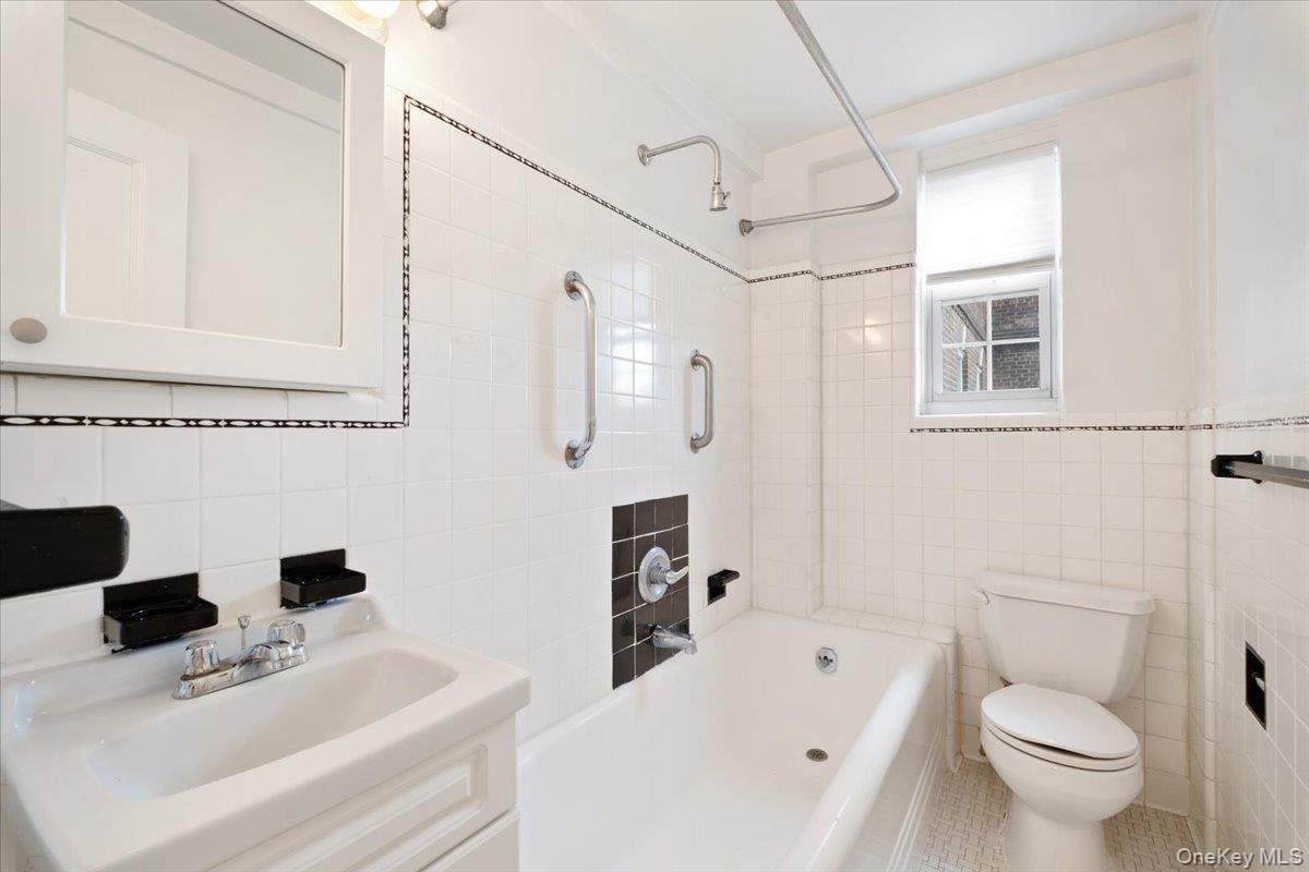45 Popham Road, Unit 4J Scarsdale, NY 10583 - Photo 15 of 28 a white toilet sitting next to a bathroom sink