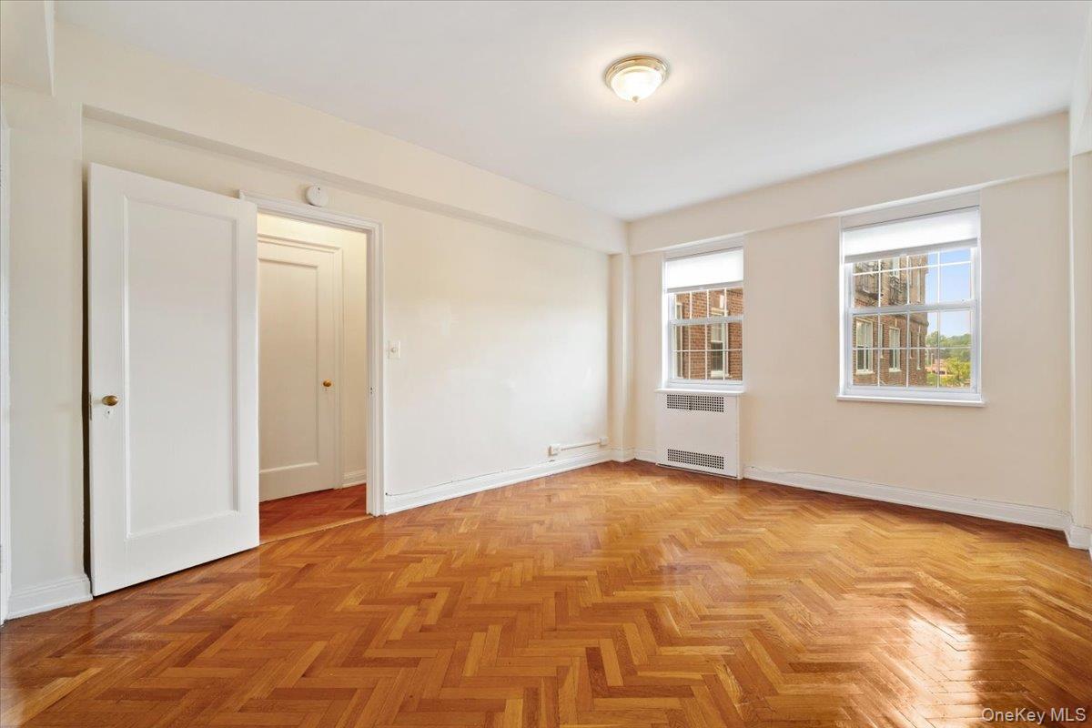 45 Popham Road, Unit 4J Scarsdale, NY 10583 - Photo 16 of 28 a view of an empty room with window and wooden floor