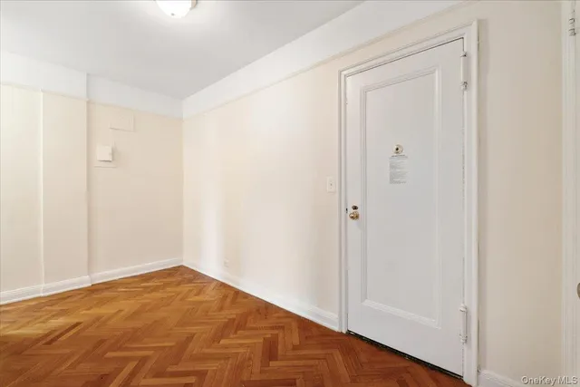 a picture of a bench in front of a wall