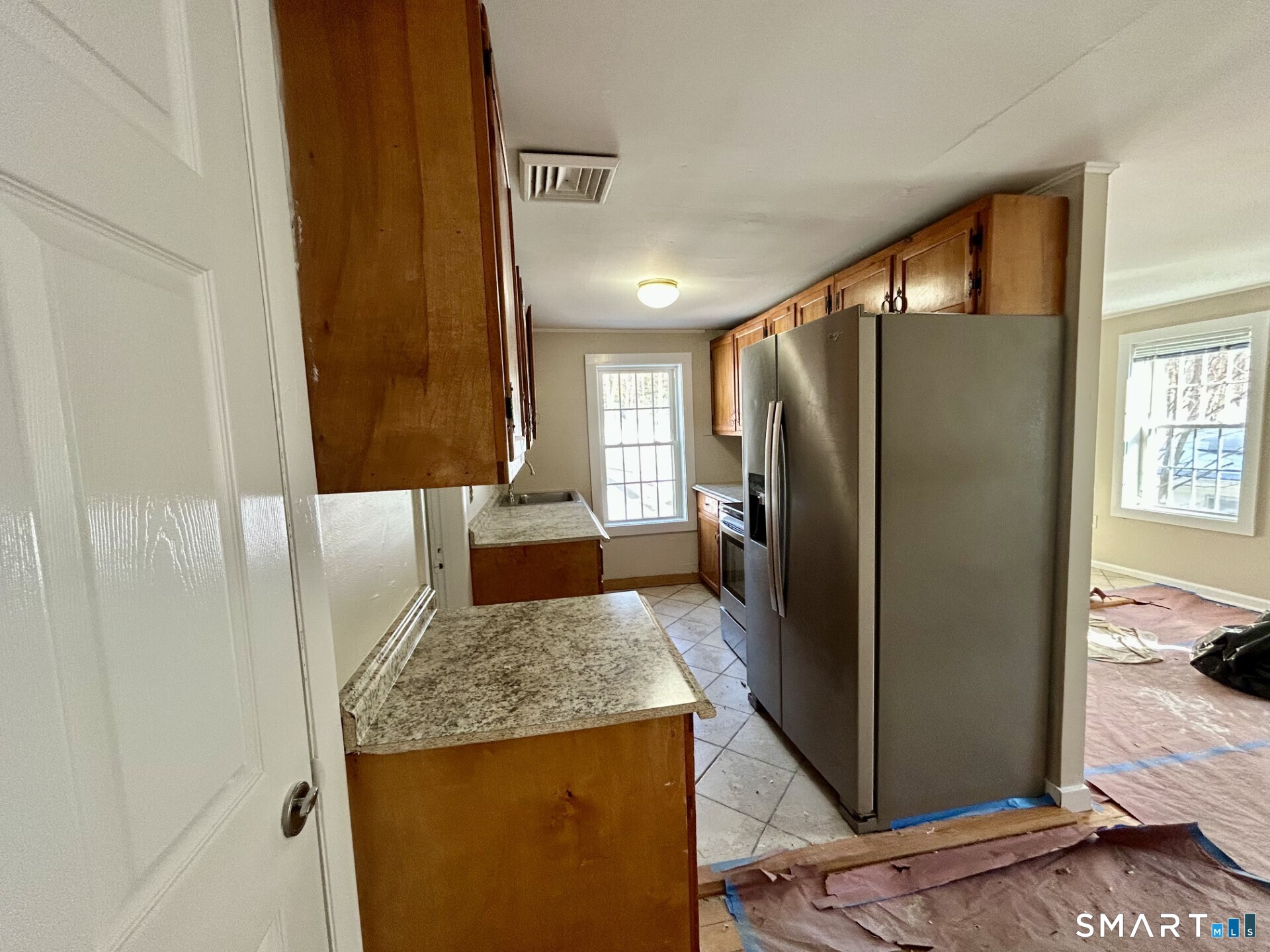 4 Weekeepeemee Road Woodbury, CT 06798 - Photo 6 of 18 a kitchen with granite countertop a refrigerator and a sink