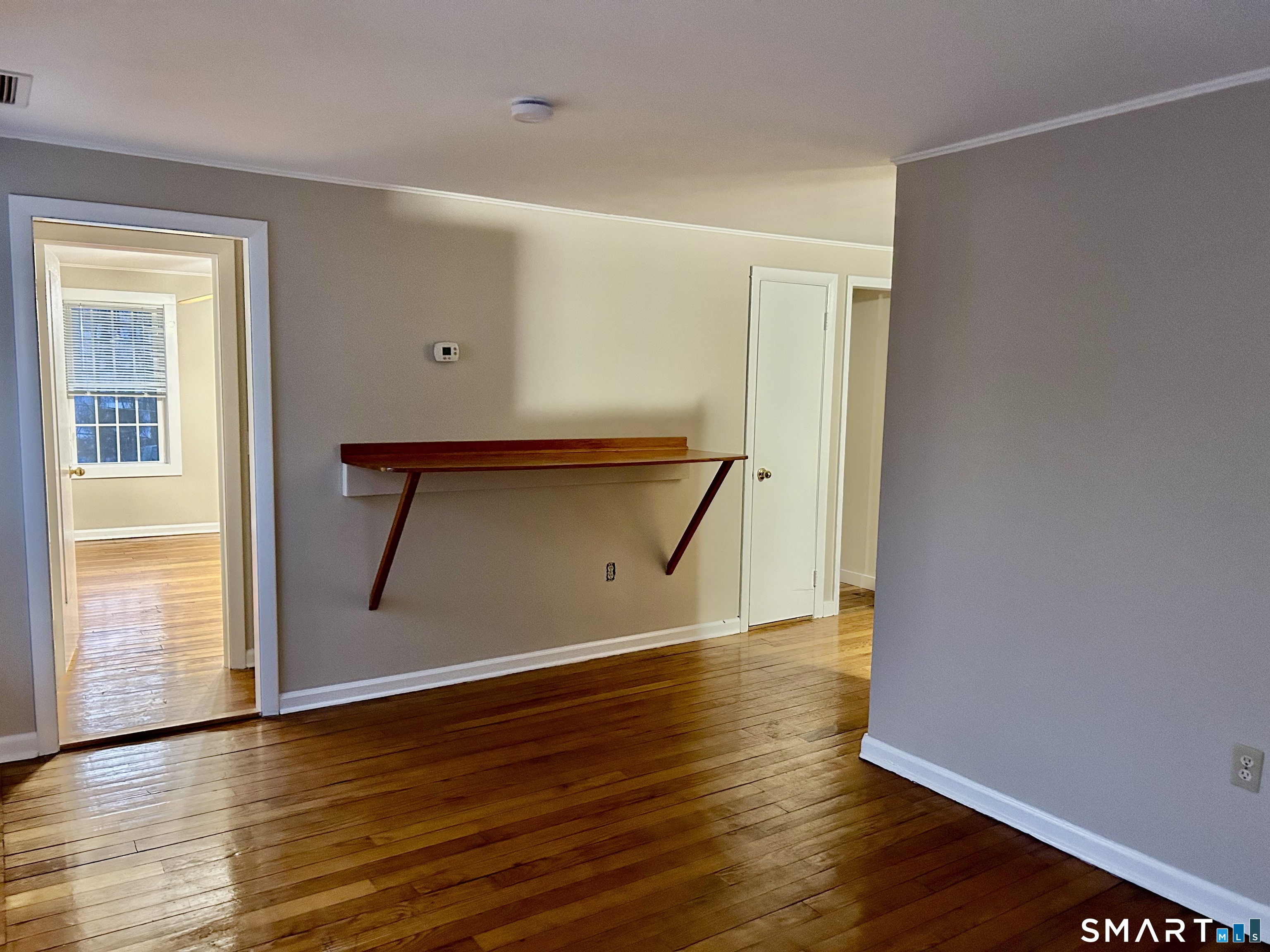 4 Weekeepeemee Road Woodbury, CT 06798 - Photo 7 of 18 a view of an empty room with wooden floor and a window