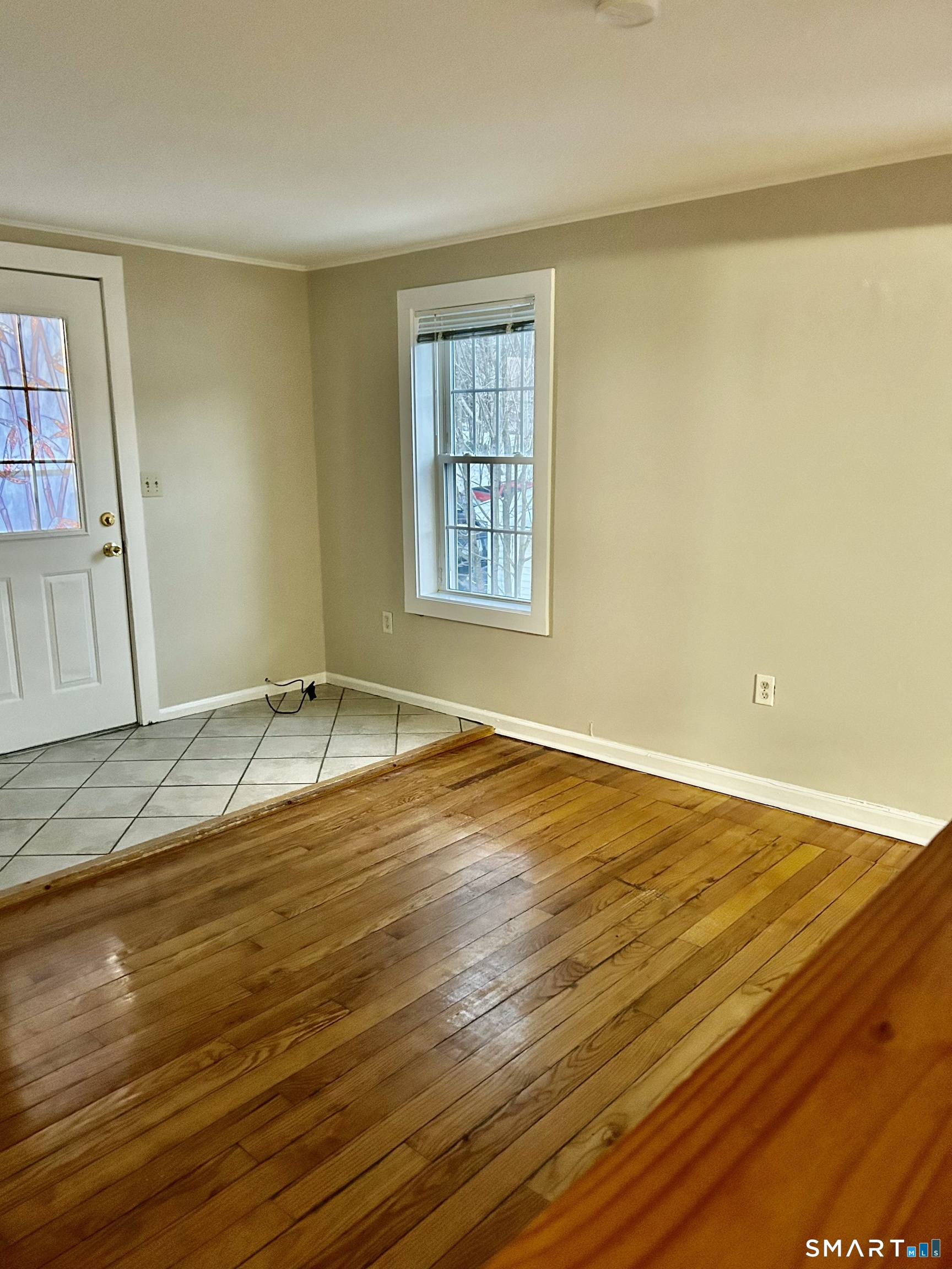 4 Weekeepeemee Road Woodbury, CT 06798 - Photo 8 of 18 a view of an empty room with wooden floor and a window