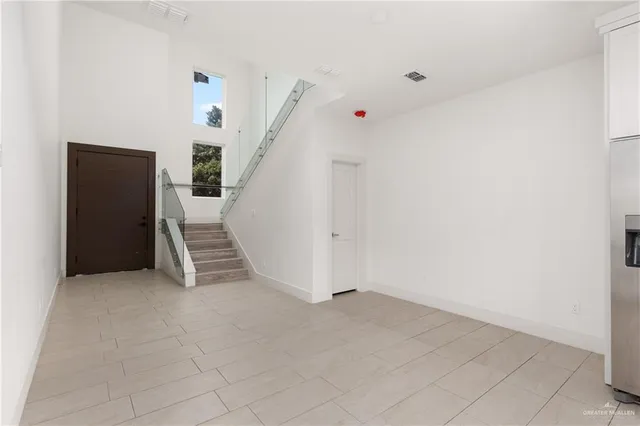 a large white kitchen with stainless steel appliances