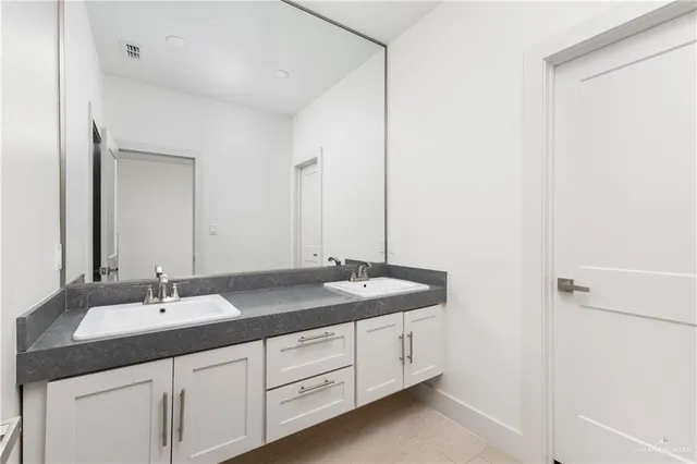 a view of a room with wooden floor and white walls