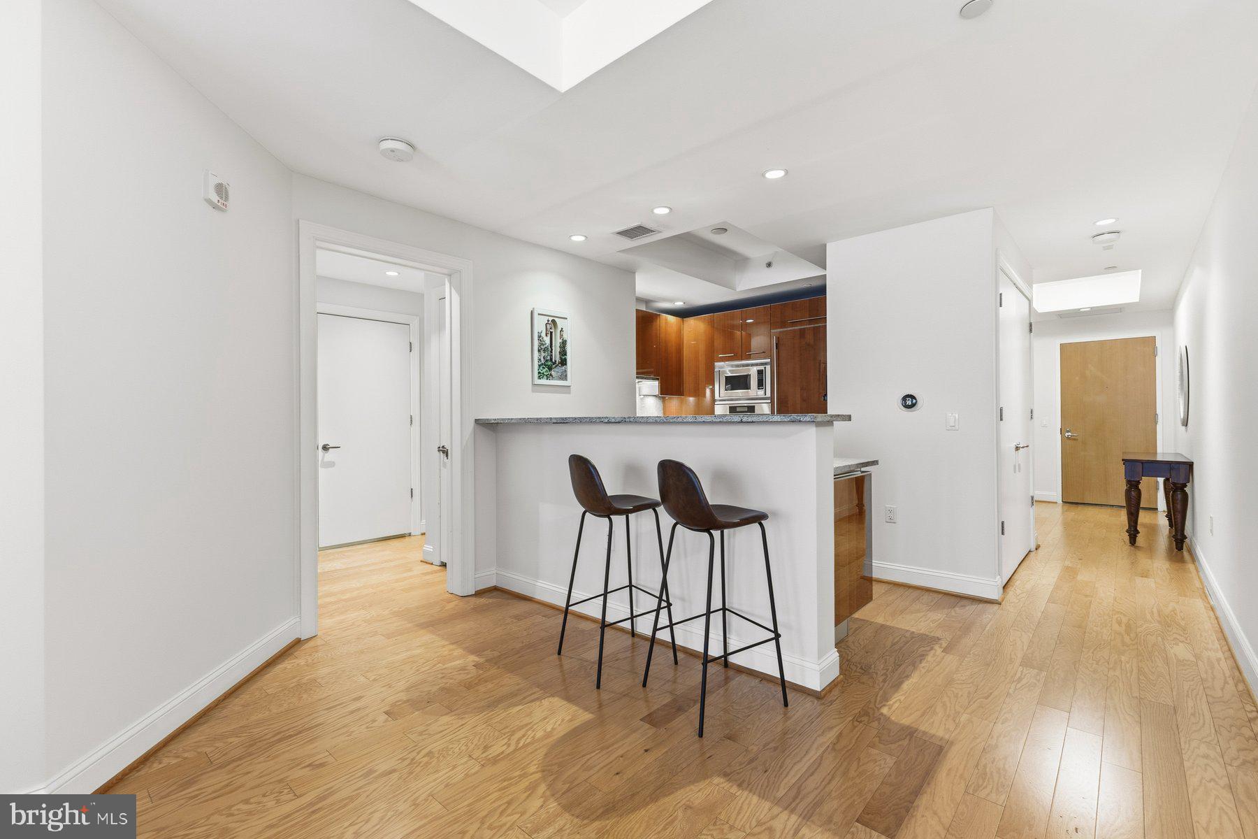 1881 North Nash Street, Unit 408 Arlington, VA 22209 - Photo 11 of 44 a view of a kitchen and dining area with chandelier