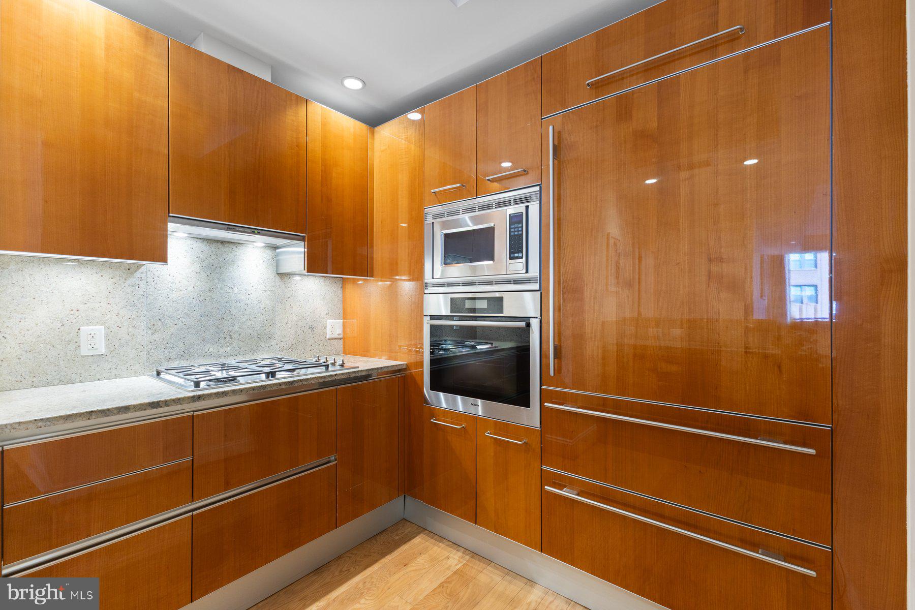 1881 North Nash Street, Unit 408 Arlington, VA 22209 - Photo 14 of 44 a kitchen with a refrigerator and a stove