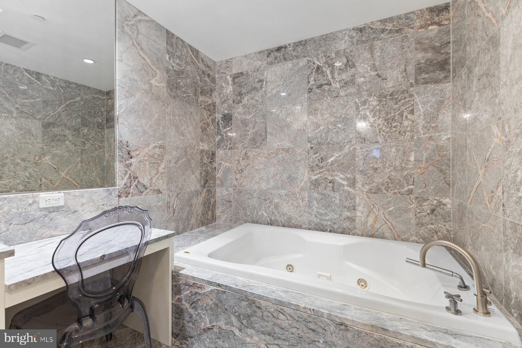 1881 North Nash Street, Unit 408 Arlington, VA 22209 - Photo 23 of 44 a bathroom with a bathtub and shower