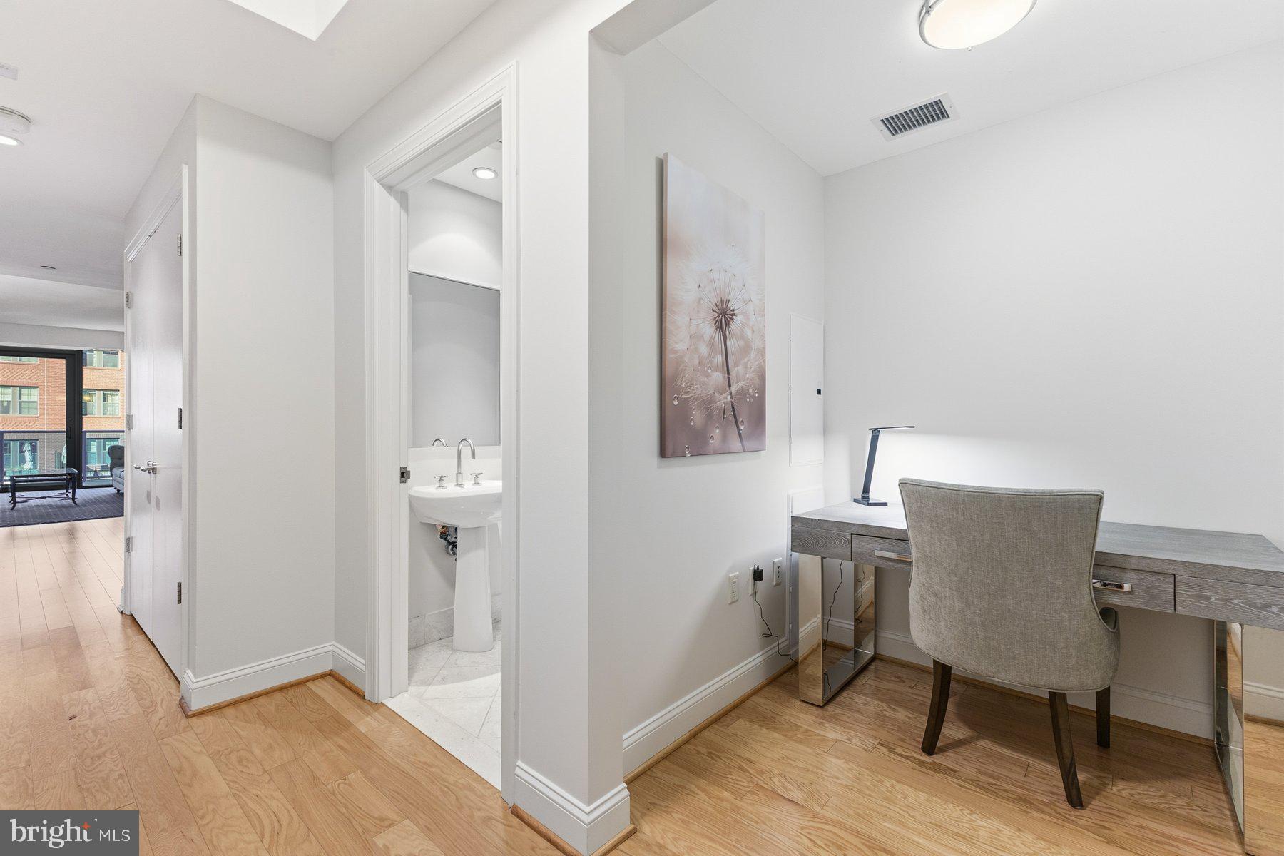 1881 North Nash Street, Unit 408 Arlington, VA 22209 - Photo 28 of 44 a view of a hallway with front door and wooden floor