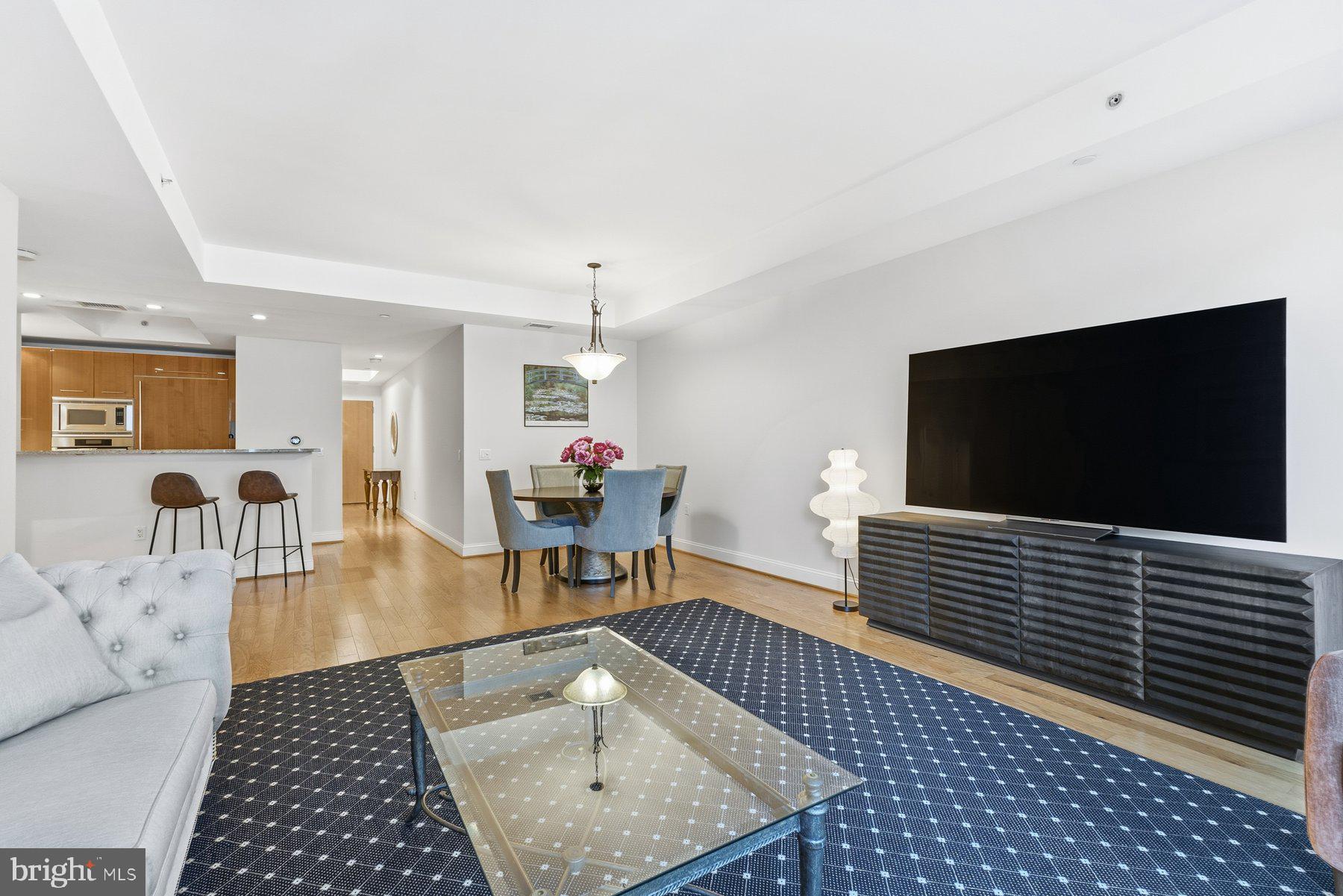 1881 North Nash Street, Unit 408 Arlington, VA 22209 - Photo 3 of 44 a living room with furniture and a flat screen tv
