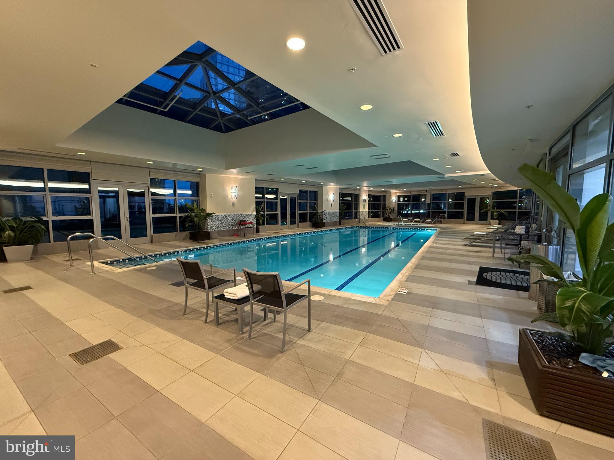 1881 North Nash Street, Unit 408 Arlington, VA 22209 - Photo 34 of 44 a view of a patio with table and chairs potted plants and large tree