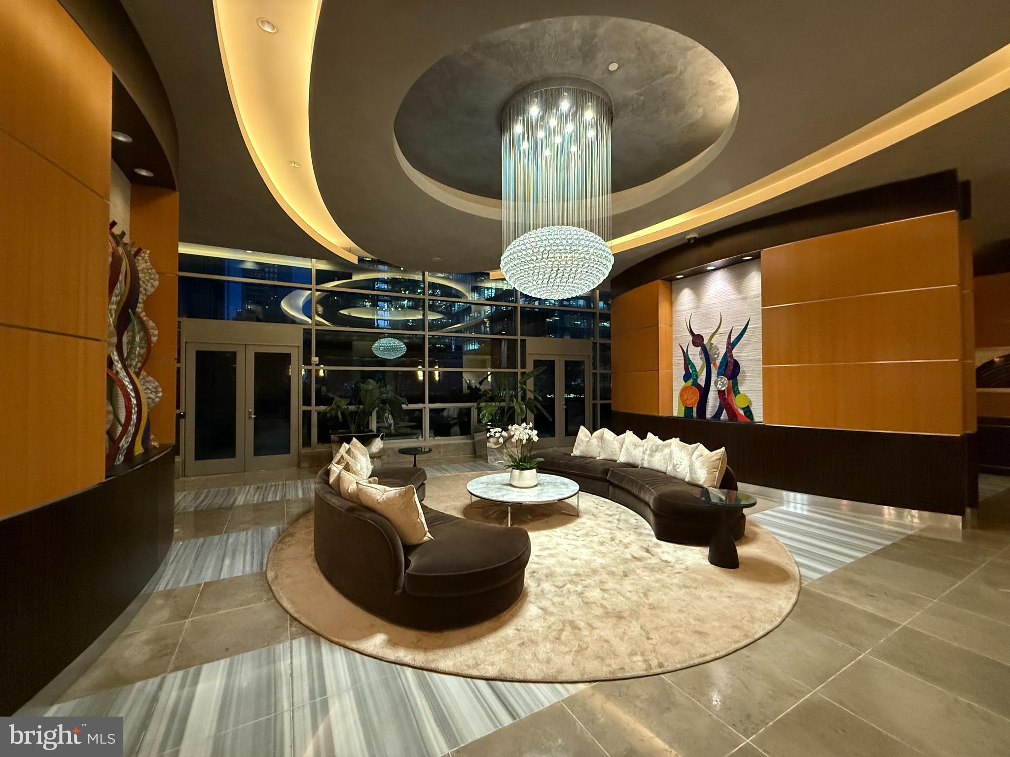 1881 North Nash Street, Unit 408 Arlington, VA 22209 - Photo 37 of 44 a dining room with fireplace furniture and a chandelier