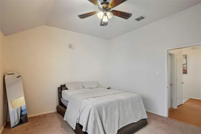 a living room with furniture ceiling fan and a window