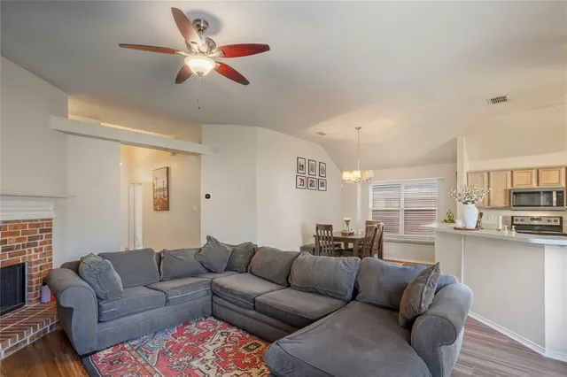 a living room with fireplace furniture and a flat screen tv
