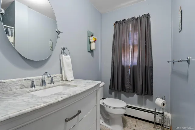a bathroom with a sink a toilet and vanity