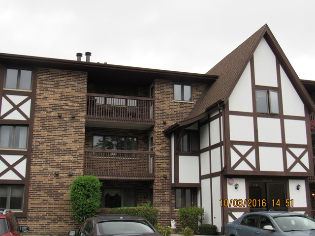 10640 Ridgeland Avenue, Unit 2A Chicago Ridge, IL 60415 - Photo 1 of 15 a front view of a building with a lot of windows