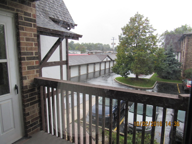 10640 Ridgeland Avenue, Unit 2A Chicago Ridge, IL 60415 - Photo 2 of 15 a view of a balcony with a table and chairs
