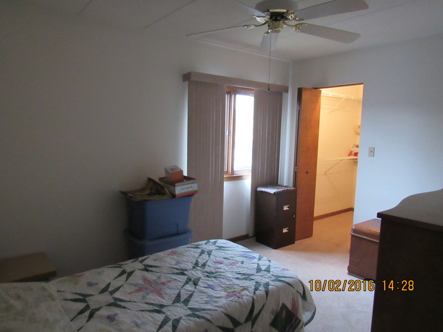 10640 Ridgeland Avenue, Unit 2A Chicago Ridge, IL 60415 - Photo 12 of 15 a bedroom with a bed and a chandelier