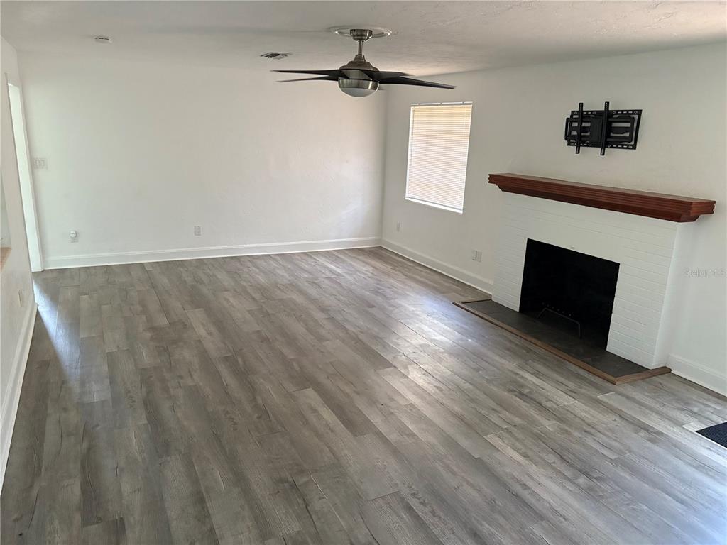 706 Northwest 20th Street Gainesville, FL 32603 - Photo 13 of 46 an empty room with windows and fireplace