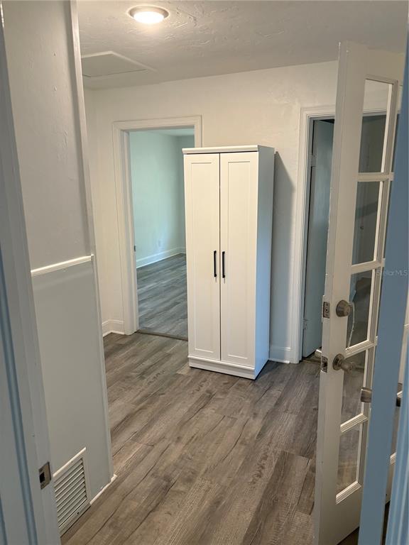 706 Northwest 20th Street Gainesville, FL 32603 - Photo 14 of 46 an empty room with wooden floor and closet