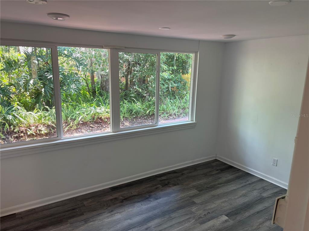 706 Northwest 20th Street Gainesville, FL 32603 - Photo 15 of 46 an empty room with wooden floor and a window