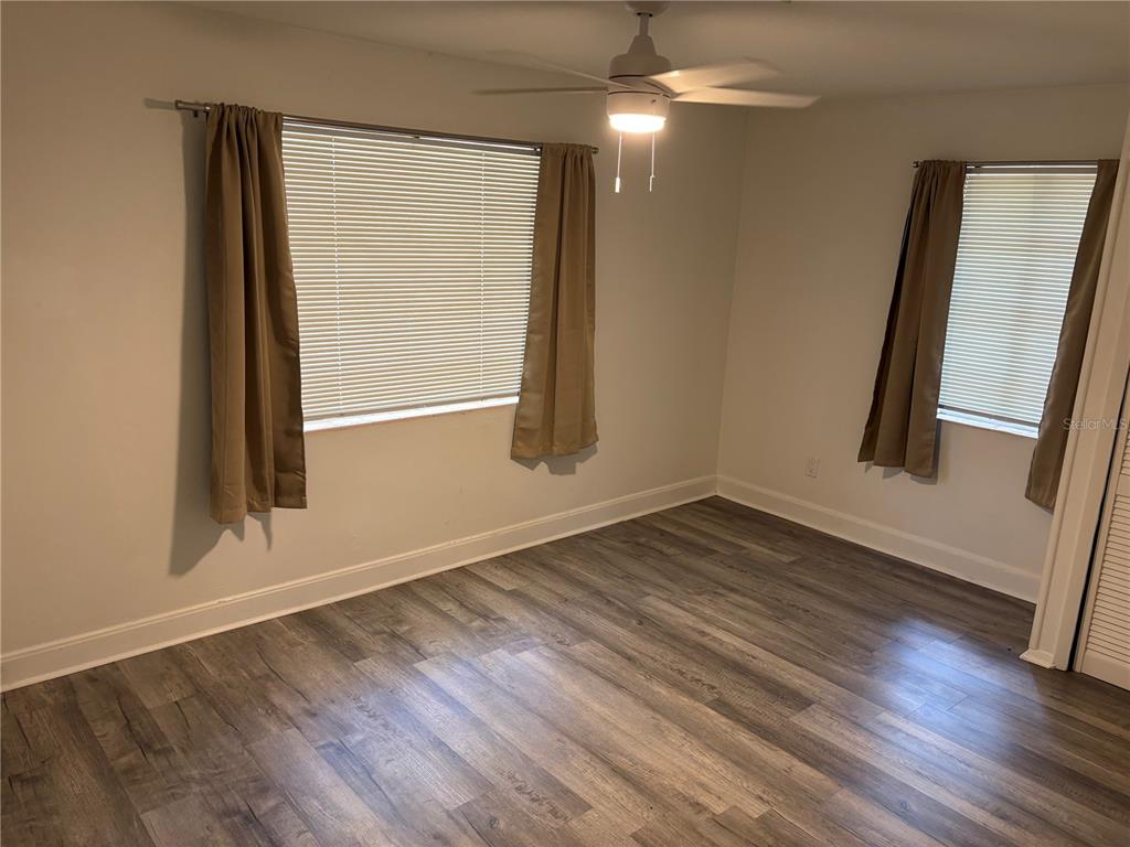 706 Northwest 20th Street Gainesville, FL 32603 - Photo 17 of 46 an empty room with wooden floor and windows