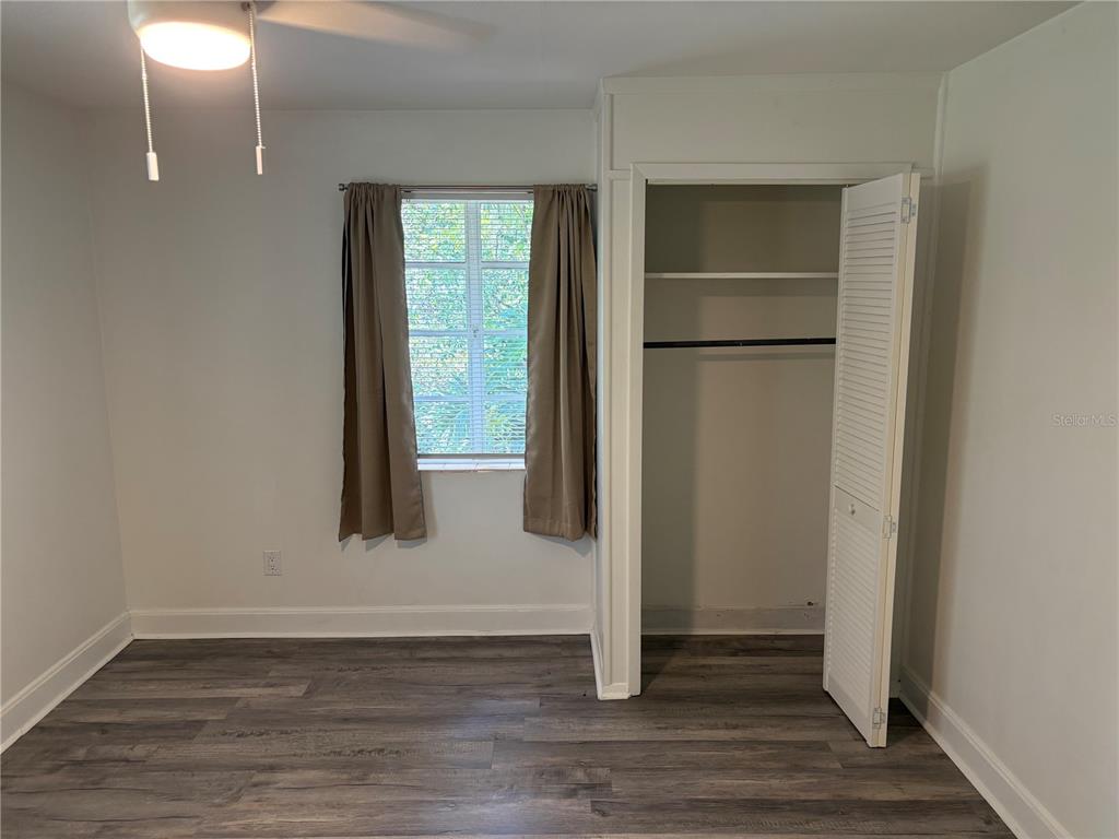 706 Northwest 20th Street Gainesville, FL 32603 - Photo 19 of 46 a view of an empty room with wooden floor and a window