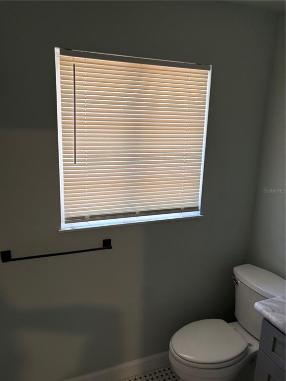 706 Northwest 20th Street Gainesville, FL 32603 - Photo 21 of 46 a bathroom with a toilet a sink and a window