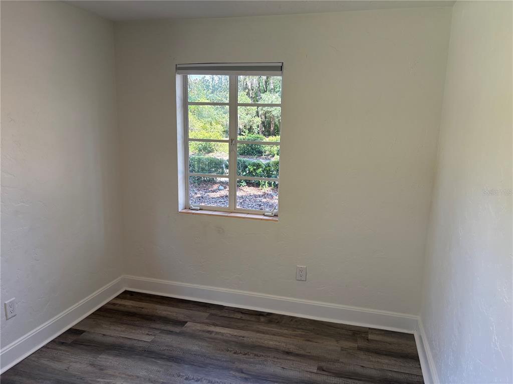 706 Northwest 20th Street Gainesville, FL 32603 - Photo 28 of 46 a view of an empty room with wooden floor and a window