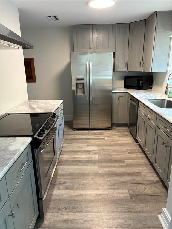 706 Northwest 20th Street Gainesville, FL 32603 - Photo 3 of 46 a kitchen with a sink stove and refrigerator