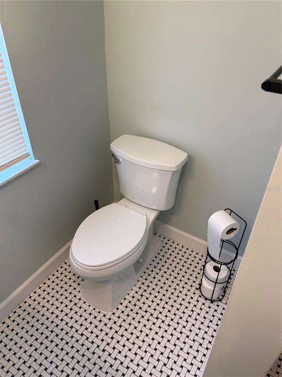 706 Northwest 20th Street Gainesville, FL 32603 - Photo 32 of 46 a bathroom with a toilet and a chair