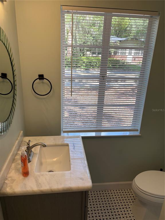 706 Northwest 20th Street Gainesville, FL 32603 - Photo 33 of 46 a bathroom with a sink toilet and window