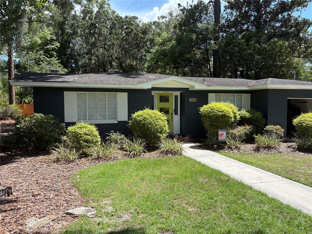 706 Northwest 20th Street Gainesville, FL 32603 - Photo 43 of 46 a front view of a house with garden and plants