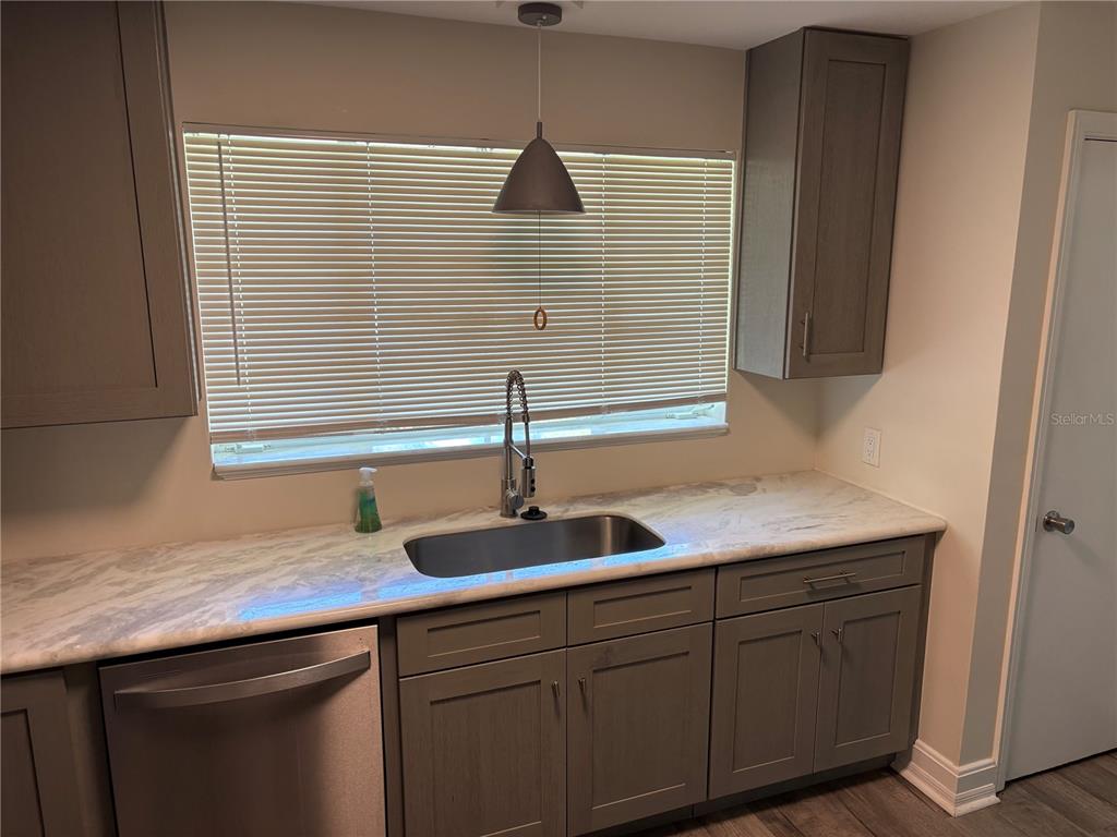 706 Northwest 20th Street Gainesville, FL 32603 - Photo 6 of 46 a kitchen with a sink and cabinets