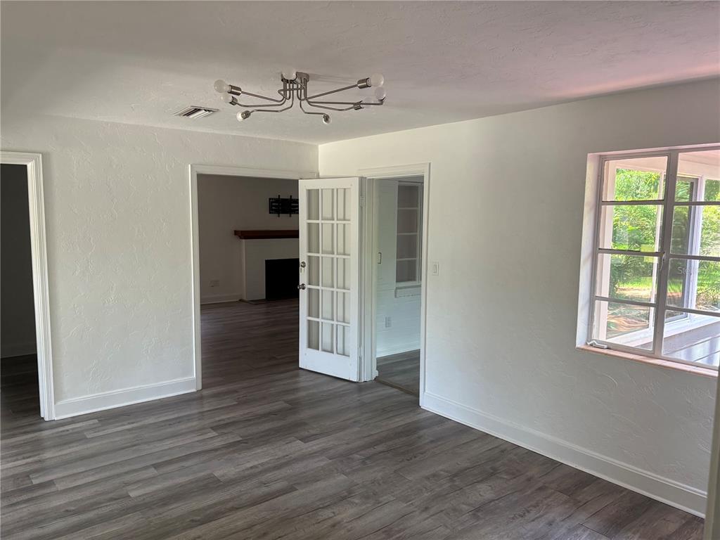 706 Northwest 20th Street Gainesville, FL 32603 - Photo 8 of 46 wooden floor in an empty room with a window