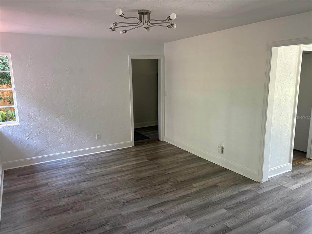 706 Northwest 20th Street Gainesville, FL 32603 - Photo 9 of 46 an empty room with wooden floor and windows