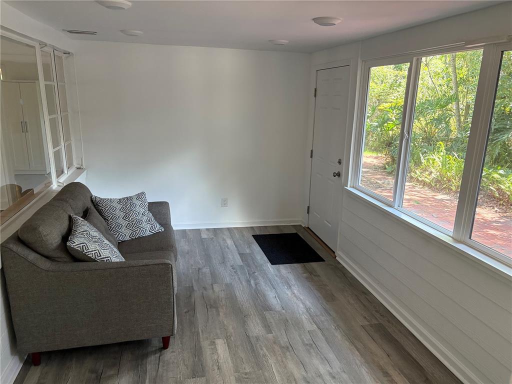 706 Northwest 20th Street Gainesville, FL 32603 - Photo 10 of 46 a living room with furniture and a large window