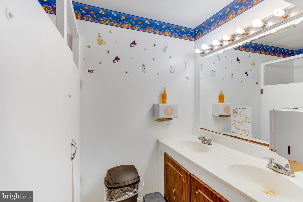 4425 Solomons Island Road Huntingtown, MD 20639 - Photo 11 of 65 a bathroom with a sink mirror vanity and toilet