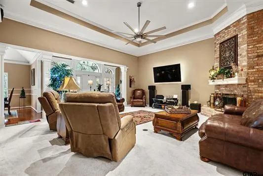 a living room with furniture a fireplace and a flat screen tv