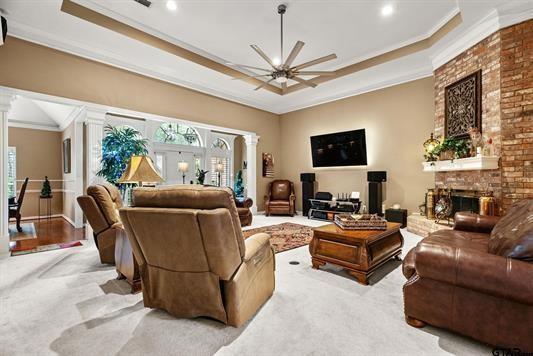 3621 Rock Creek Drive Tyler, TX 75707 - Photo 11 of 29 a living room with furniture a fireplace and a flat screen tv