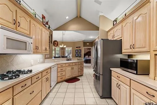 a kitchen with stainless steel appliances a refrigerator sink and stove