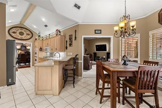 a view of a dining room with furniture and a chandelier