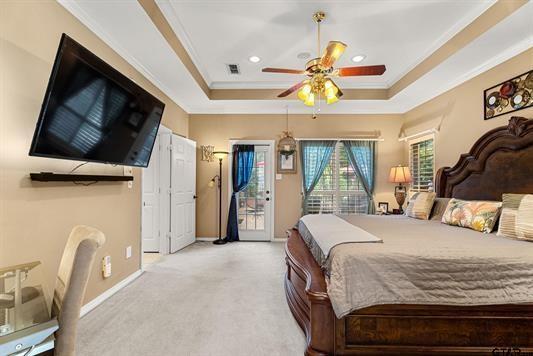 3621 Rock Creek Drive Tyler, TX 75707 - Photo 20 of 29 a bedroom with a bed a flat screen tv and a chandelier